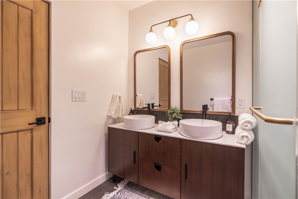 259 Victoria Sugarloaf, CA 92386 - Photo 16 of 32 a bathroom with a double vanity sink and a mirror