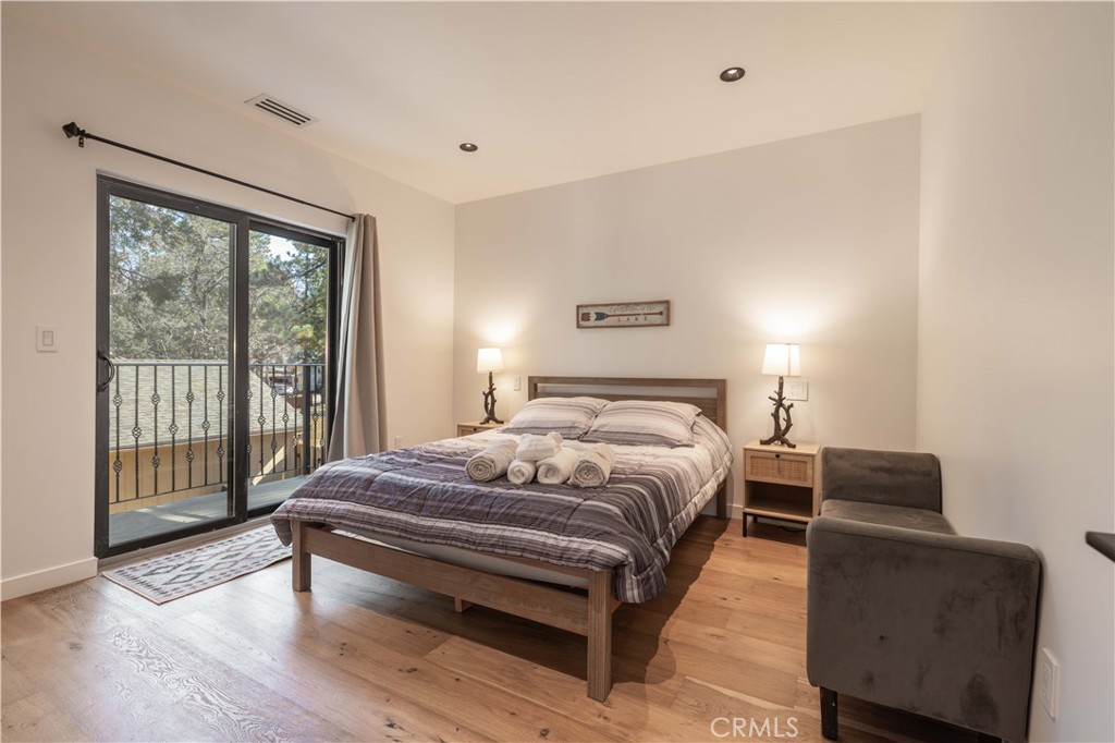 259 Victoria Sugarloaf, CA 92386 - Photo 18 of 32 a bedroom with a bed and wooden floor