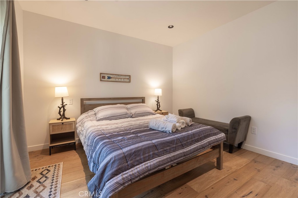 259 Victoria Sugarloaf, CA 92386 - Photo 19 of 32 a bedroom with a bed and a chair