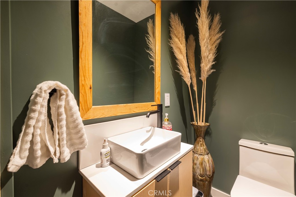 259 Victoria Sugarloaf, CA 92386 - Photo 25 of 32 a bathroom with a sink toilet and a mirror