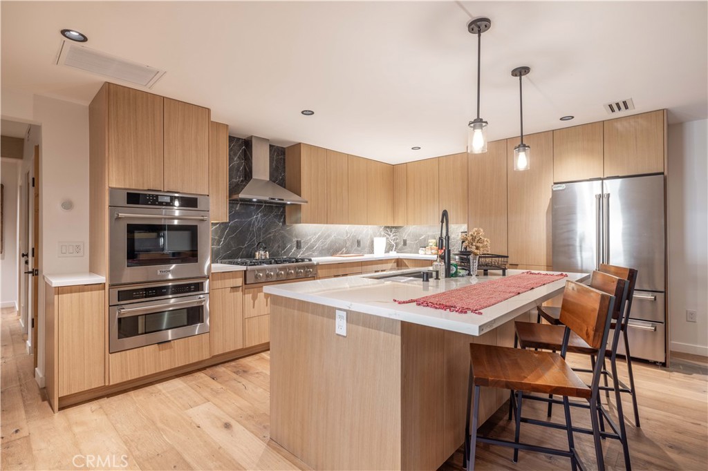 259 Victoria Sugarloaf, CA 92386 - Photo 6 of 32 a kitchen with stainless steel appliances a stove a sink island and a refrigerator