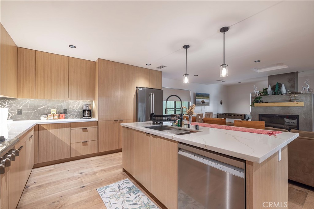 259 Victoria Sugarloaf, CA 92386 - Photo 7 of 32 a kitchen with stainless steel appliances granite countertop a sink a stove and a wooden floors