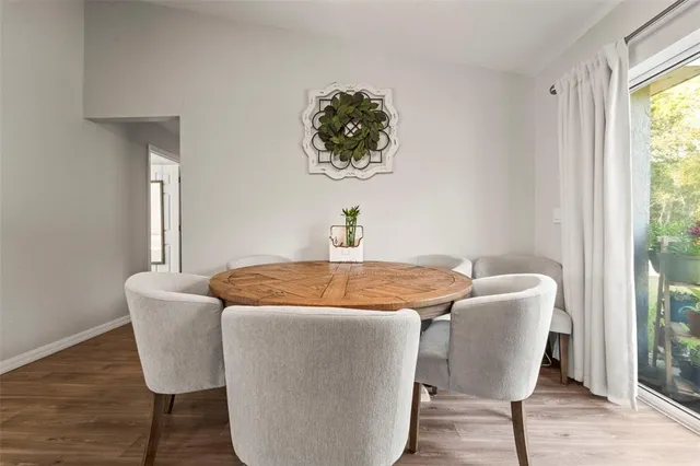 a dining room with furniture and wooden floor