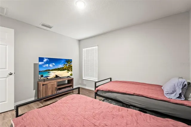 a bedroom with a bed and a book shelf