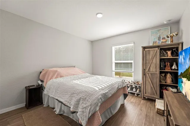 a bedroom with a bed and a tv on table