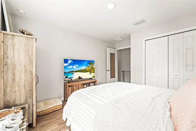 a bedroom with a bed and a mirror