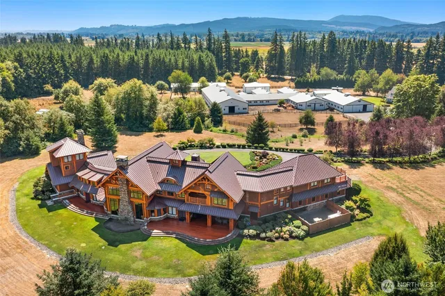 an aerial view of residential houses with outdoor space and lake view