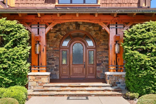 a living room with fireplace furniture and a large window
