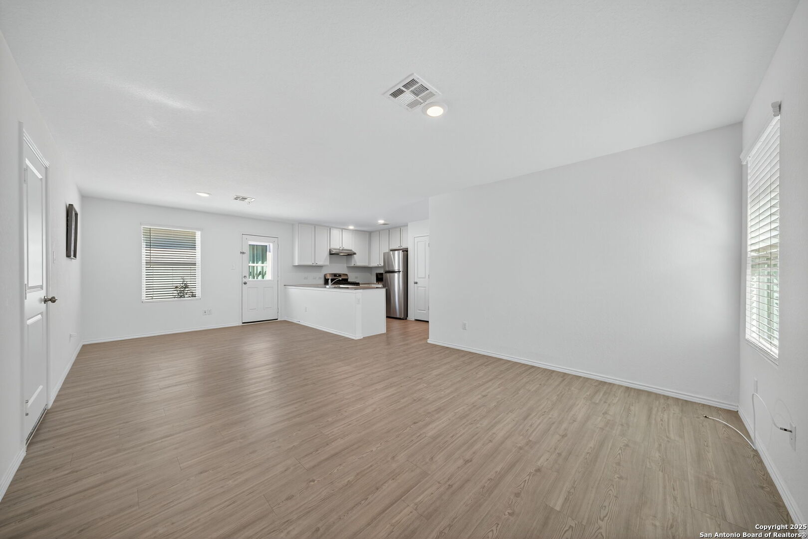 12935 Deep Eddy St. Hedwig, TX 78152 - Photo 11 of 26 a view of empty room with wooden floor and window