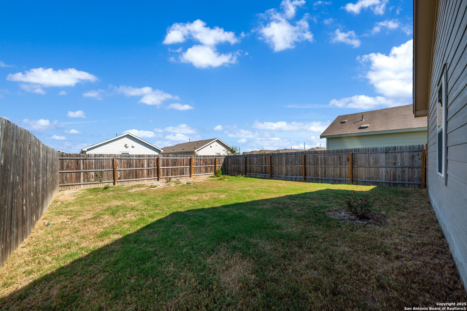 12935 Deep Eddy St. Hedwig, TX 78152 - Photo 24 of 26 a view of a house with a backyard and a tree