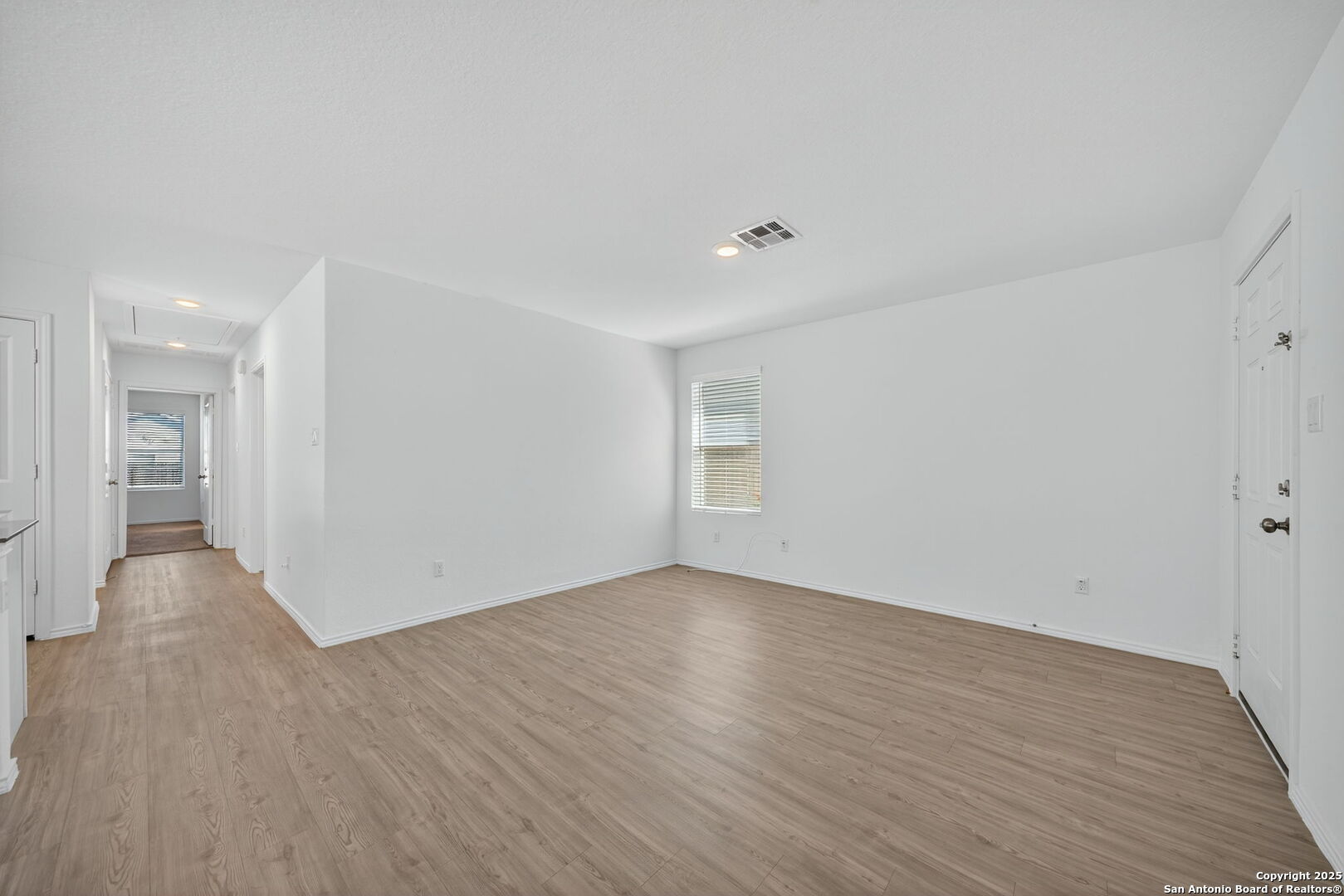 12935 Deep Eddy St. Hedwig, TX 78152 - Photo 10 of 26 a view of an empty room with wooden floor and a window