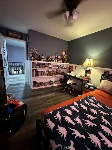 a spacious bedroom with a bed a table and a chandelier