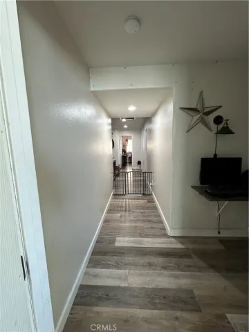 a view of a patio with table and chairs potted plants and large tree