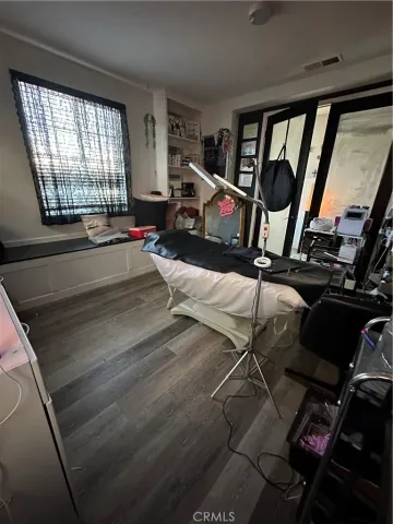 a living room with stainless steel appliances kitchen island granite countertop furniture a fireplace and a flat screen tv