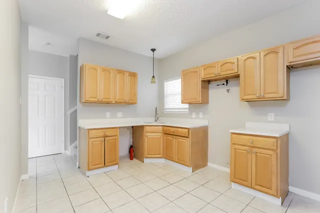 a kitchen with stainless steel appliances granite countertop a sink and cabinets