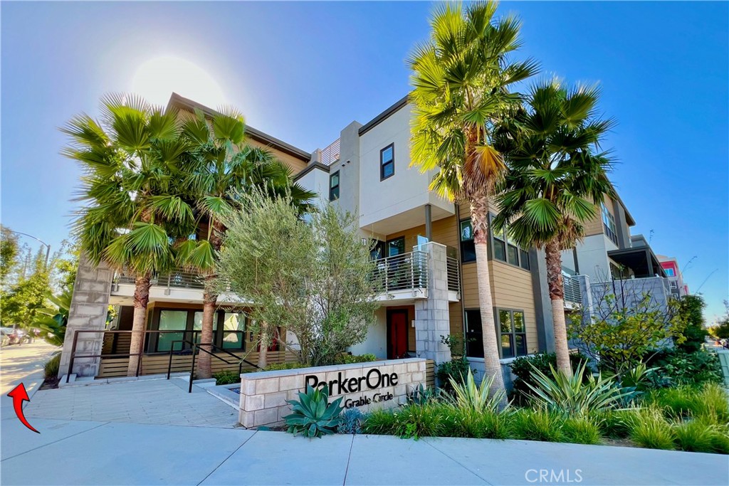 a palm tree sitting in front of a building