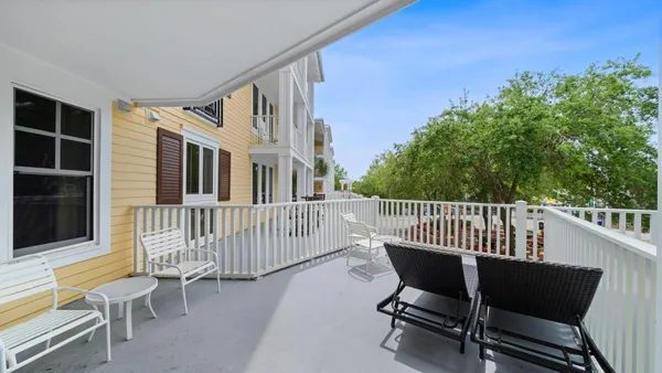 a view of a chair and table in the balcony