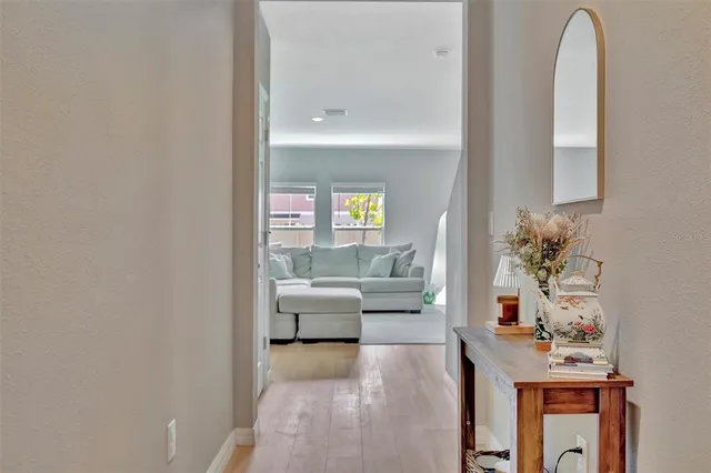 a living room with furniture and a potted plant