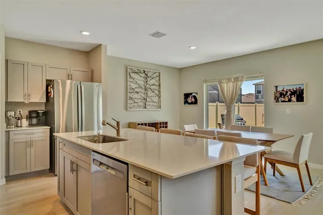 a kitchen with stainless steel appliances a sink and a refrigerator