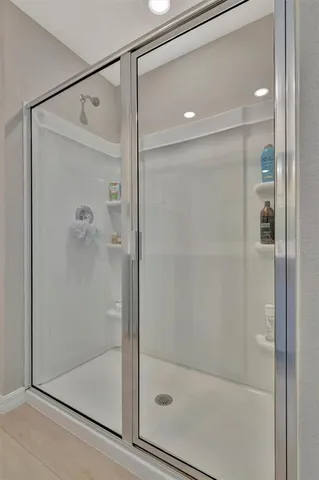 a bathroom that has a glass shower door
