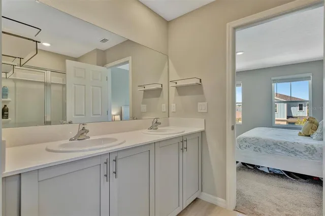 a en suite bathroom with a sink and a mirror