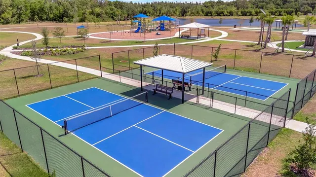 a view of a tennis court with sitting area
