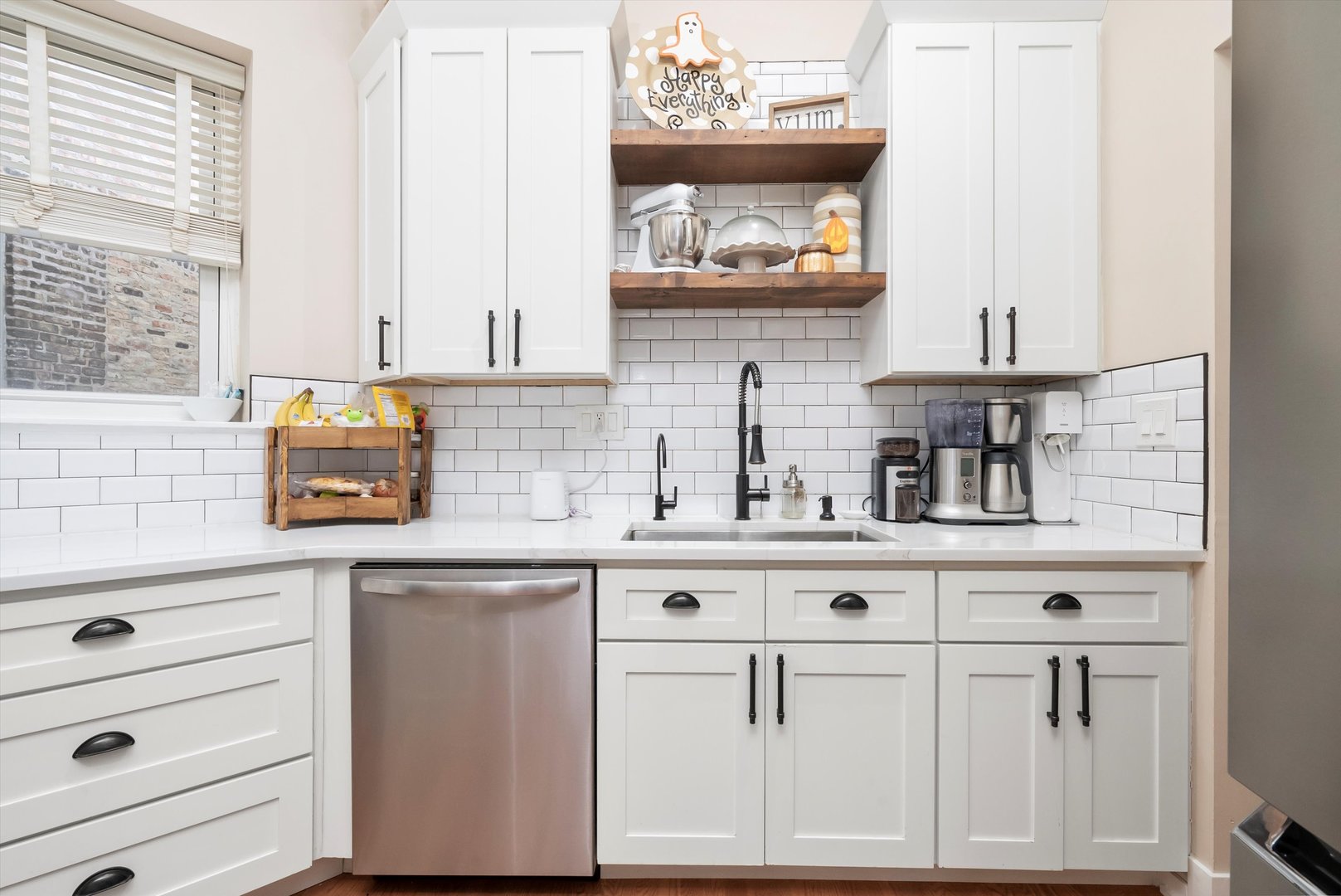 2839 North Burling Street, Unit 3N Chicago, IL 60657 - Photo 12 of 32 a kitchen with white cabinets and a wooden floor