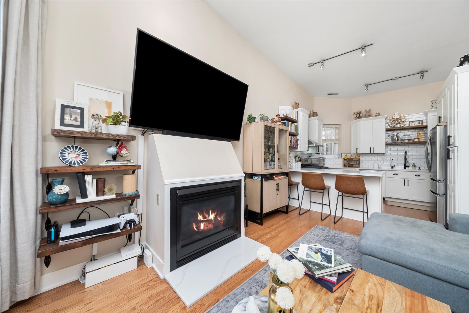 2839 North Burling Street, Unit 3N Chicago, IL 60657 - Photo 6 of 32 a living room with furniture a flat screen tv and a fireplace