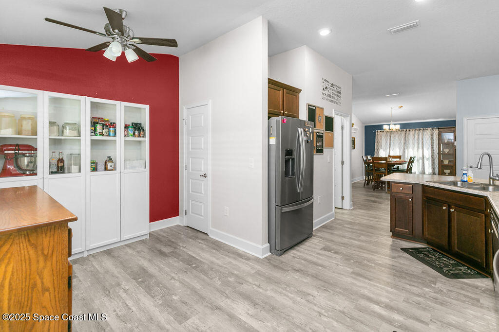 711 Tupelo Circle Cocoa, FL 32926 - Photo 14 of 47 a kitchen with stainless steel appliances kitchen island granite countertop a refrigerator and a sink