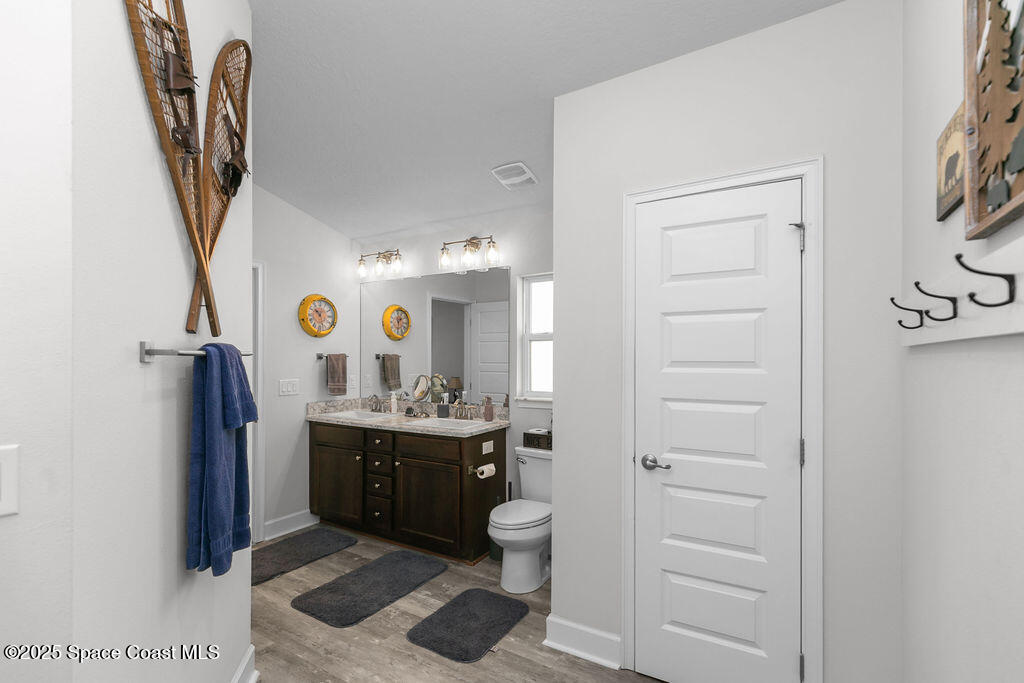 711 Tupelo Circle Cocoa, FL 32926 - Photo 25 of 47 a bathroom with a sink a toilet and mirror