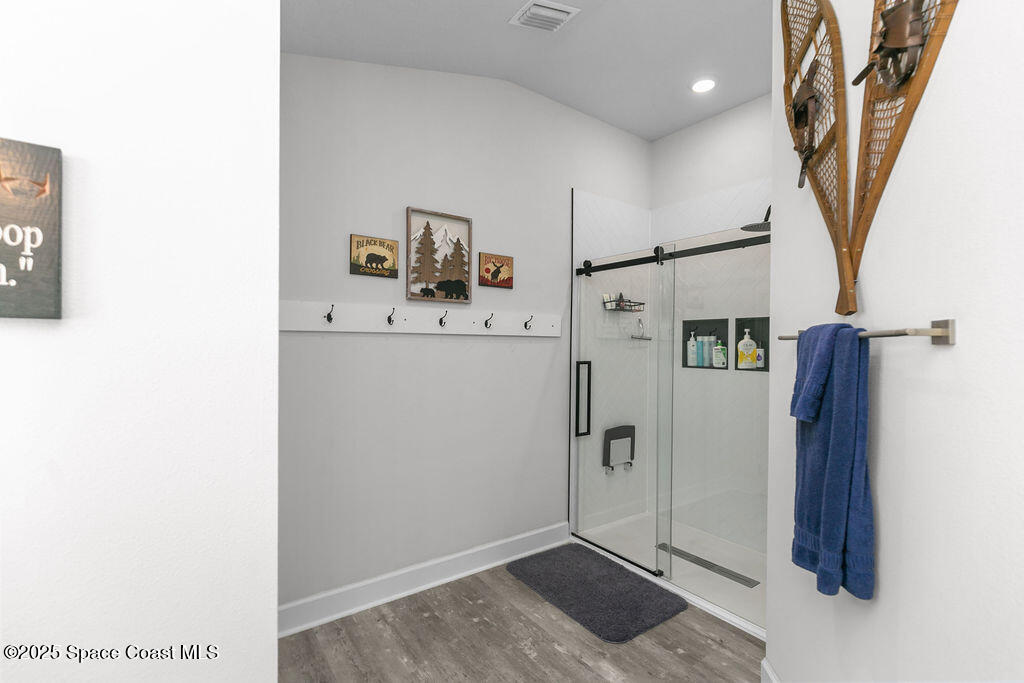 711 Tupelo Circle Cocoa, FL 32926 - Photo 26 of 47 a view of a hallway with bathroom and wooden floor