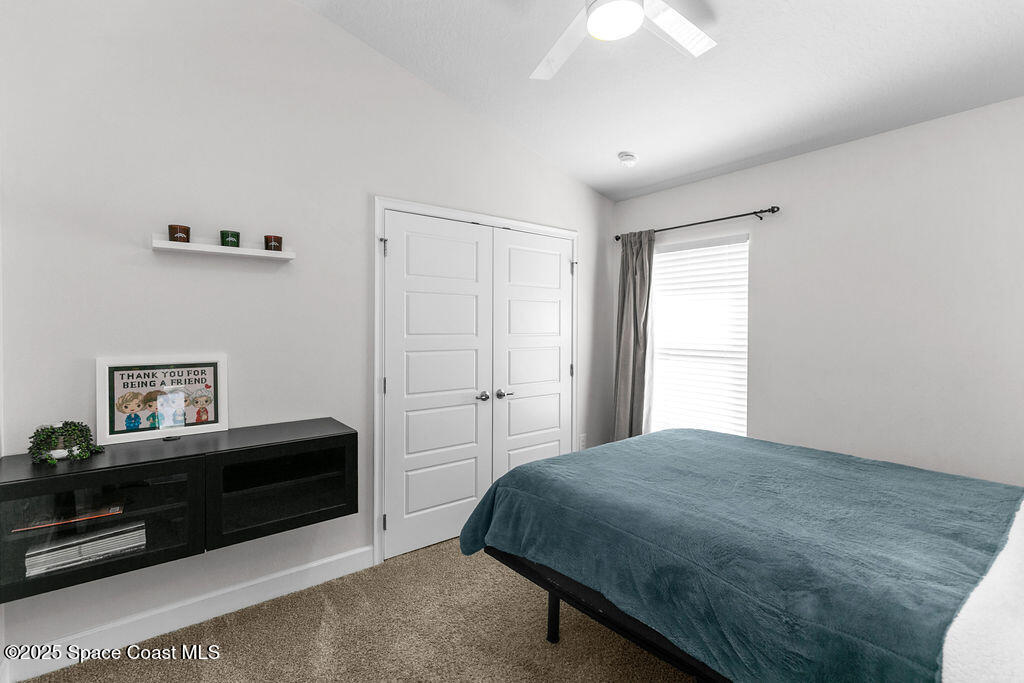 711 Tupelo Circle Cocoa, FL 32926 - Photo 28 of 47 a bedroom with a bed and a chandelier