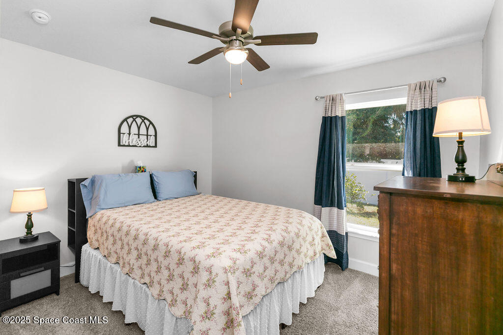 711 Tupelo Circle Cocoa, FL 32926 - Photo 30 of 47 a bedroom with a large bed and a window