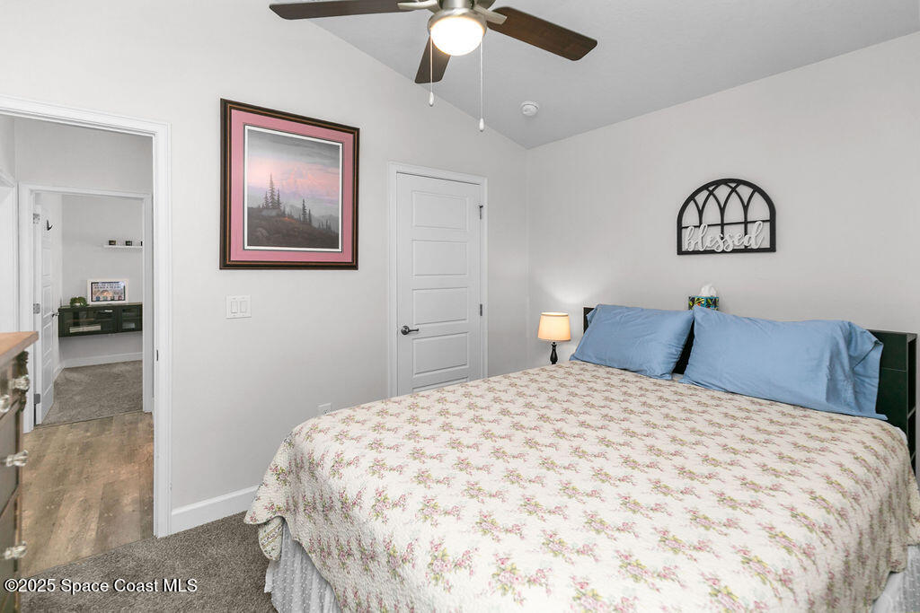 711 Tupelo Circle Cocoa, FL 32926 - Photo 31 of 47 a bedroom with a bed and a painting on the wall