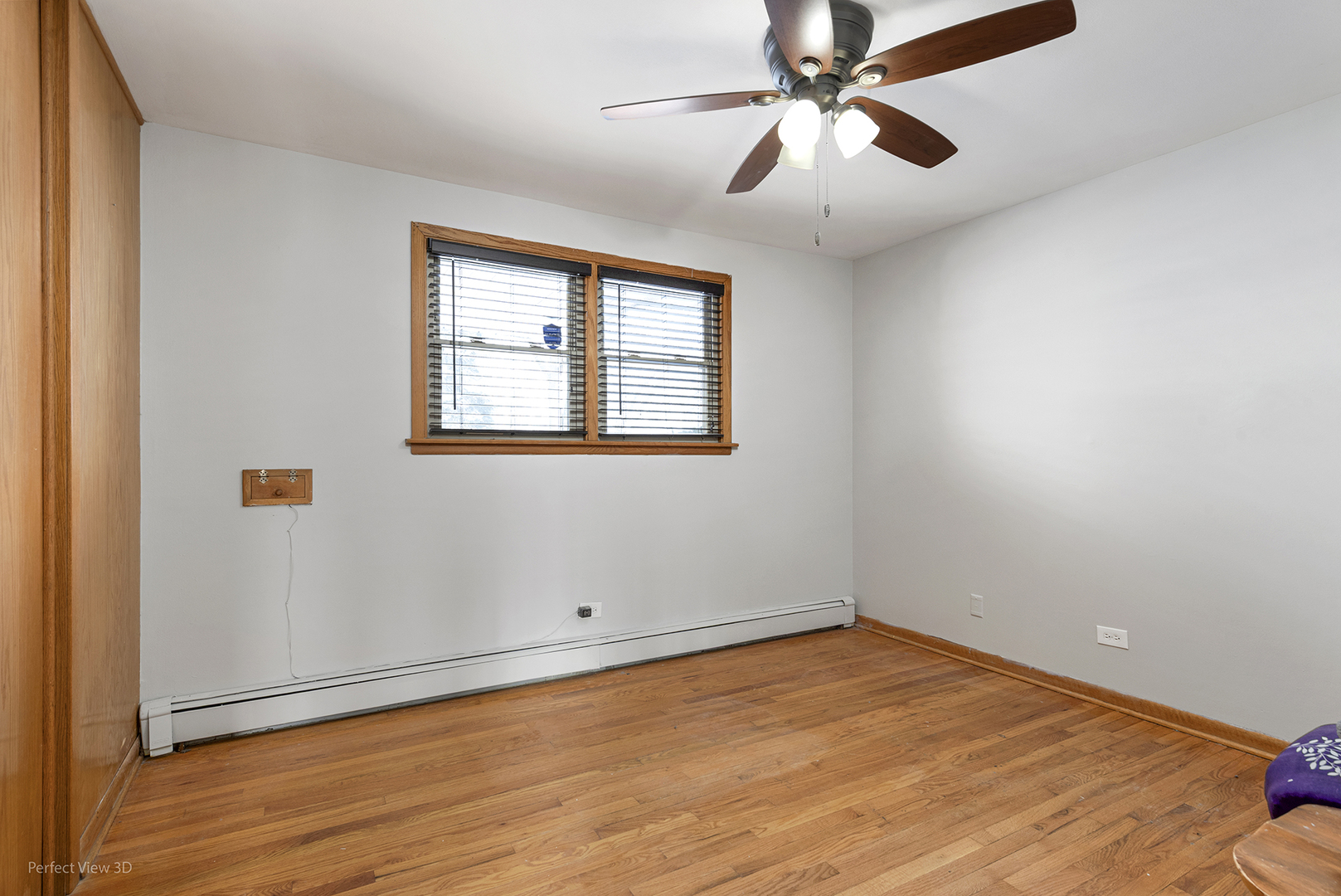 10900 Rutherford Avenue Worth, IL 60482 - Photo 11 of 21 an empty room with wooden floor chandelier fan and windows