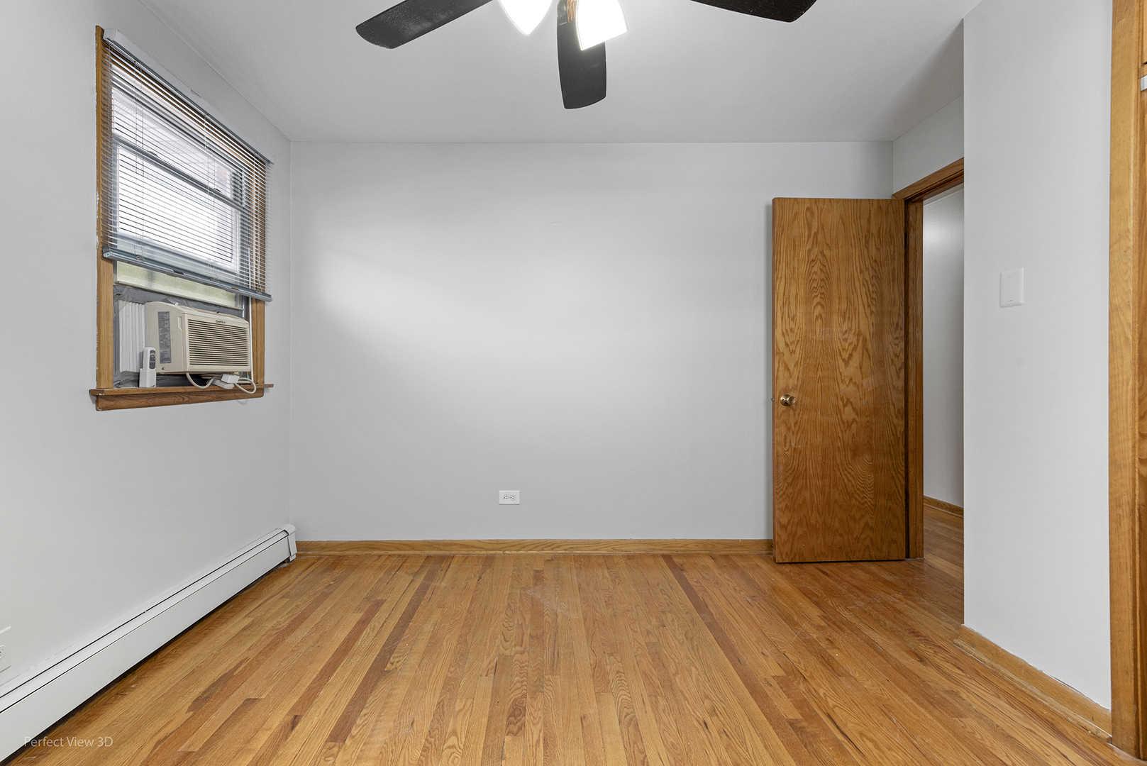 10900 Rutherford Avenue Worth, IL 60482 - Photo 16 of 21 an empty room with wooden floor and windows