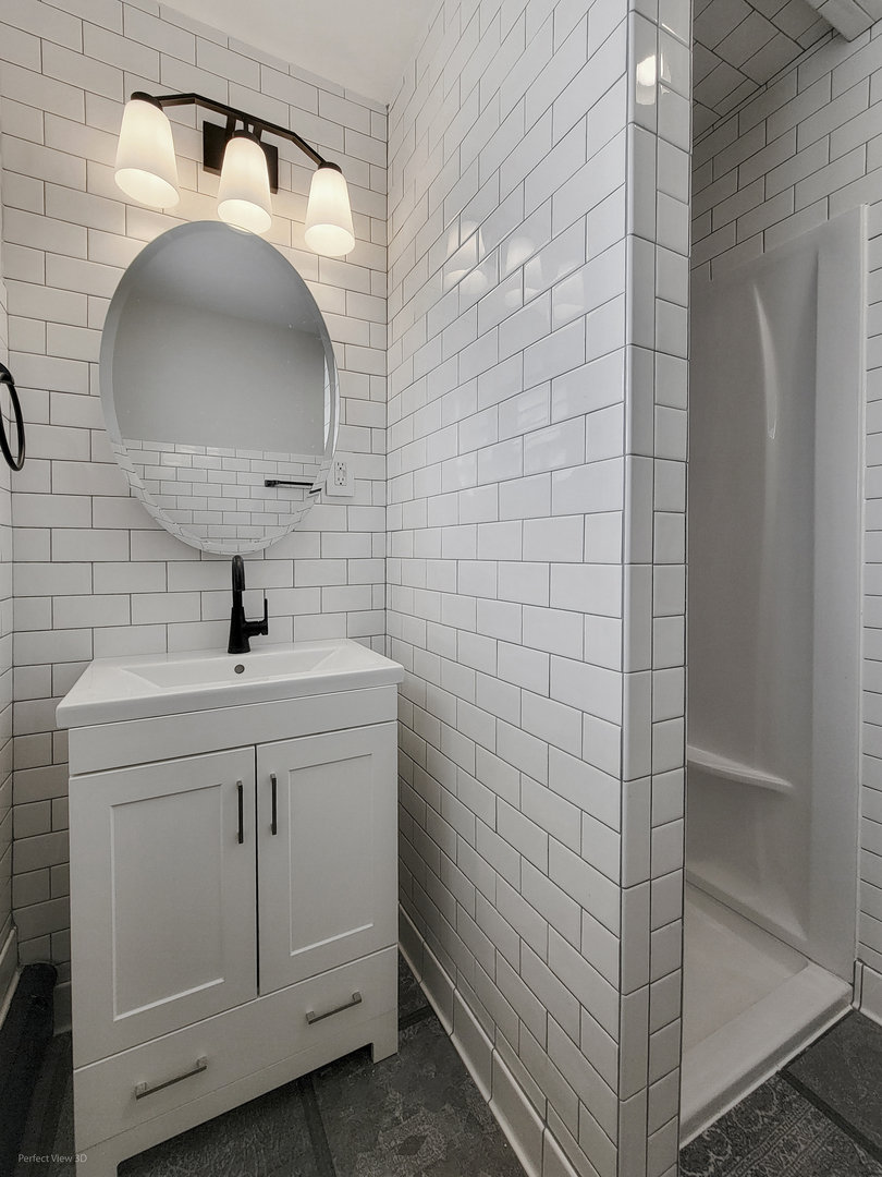 10900 Rutherford Avenue Worth, IL 60482 - Photo 18 of 21 a bathroom with a sink a vanity and a mirror