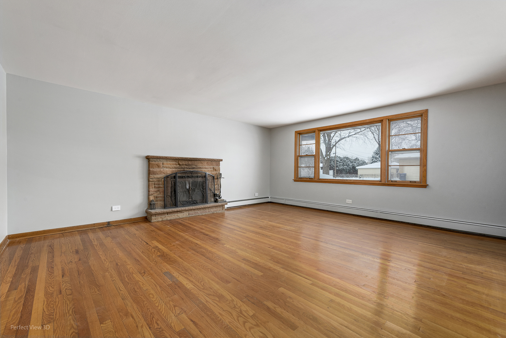 10900 Rutherford Avenue Worth, IL 60482 - Photo 3 of 21 an empty room with wooden floor fireplace and windows