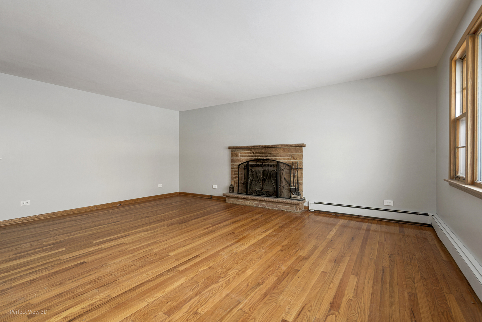 10900 Rutherford Avenue Worth, IL 60482 - Photo 4 of 21 an empty room with wooden floor and fireplace