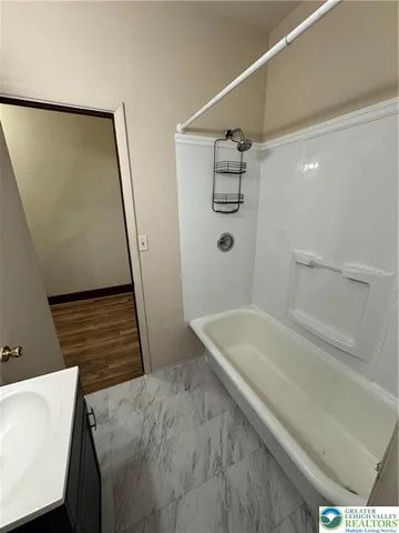 a bathroom with a sink and a shower