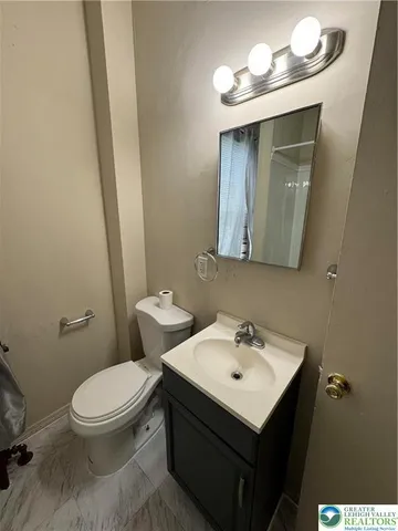 a white toilet sitting next to a bathroom sink