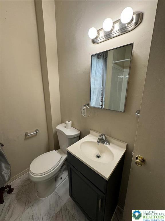 1503 Washington Street, Unit 2 Wilson, PA 18042 - Photo 12 of 28 a white toilet sitting next to a bathroom sink