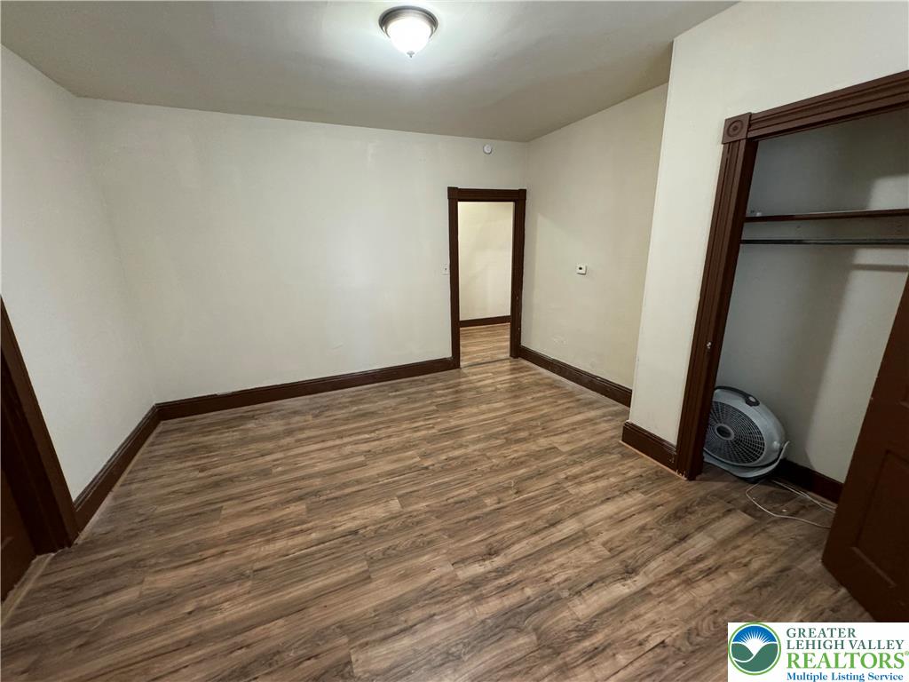 1503 Washington Street, Unit 2 Wilson, PA 18042 - Photo 15 of 28 an empty room with wooden floor and mirror