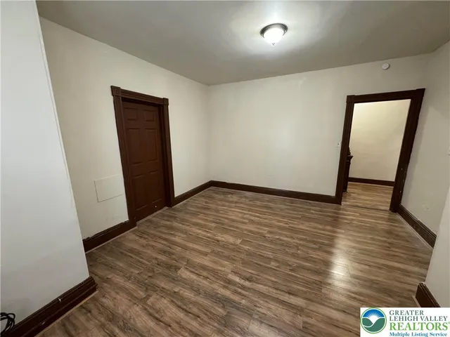 a view of hallway with wooden floor