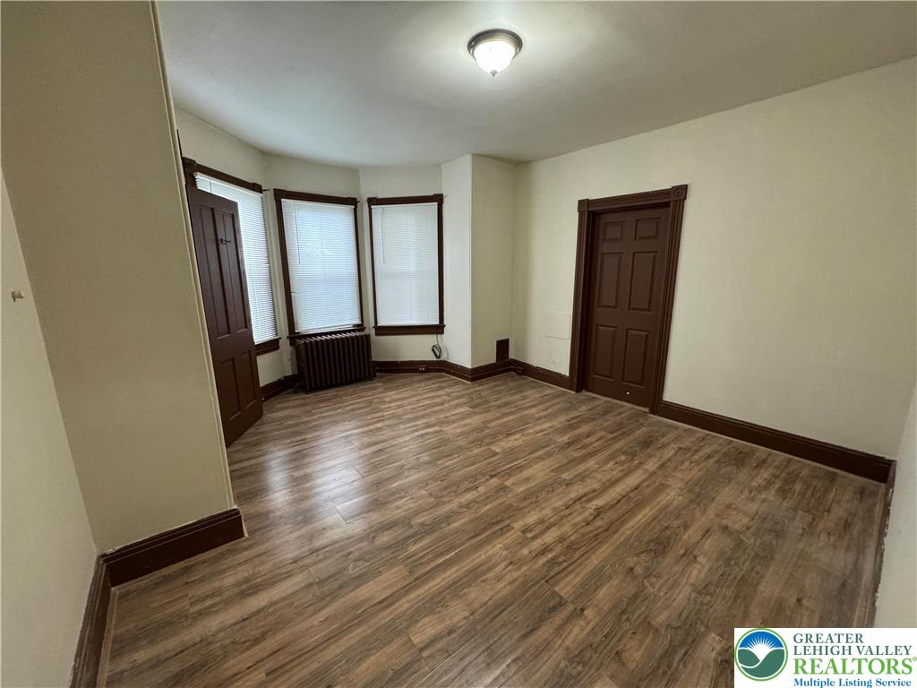 1503 Washington Street, Unit 2 Wilson, PA 18042 - Photo 17 of 28 a view of an empty room with wooden floor and a window