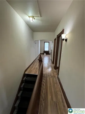 a view of a hallway with furniture