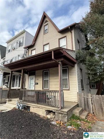 a view of a house with a window and wooden fence
