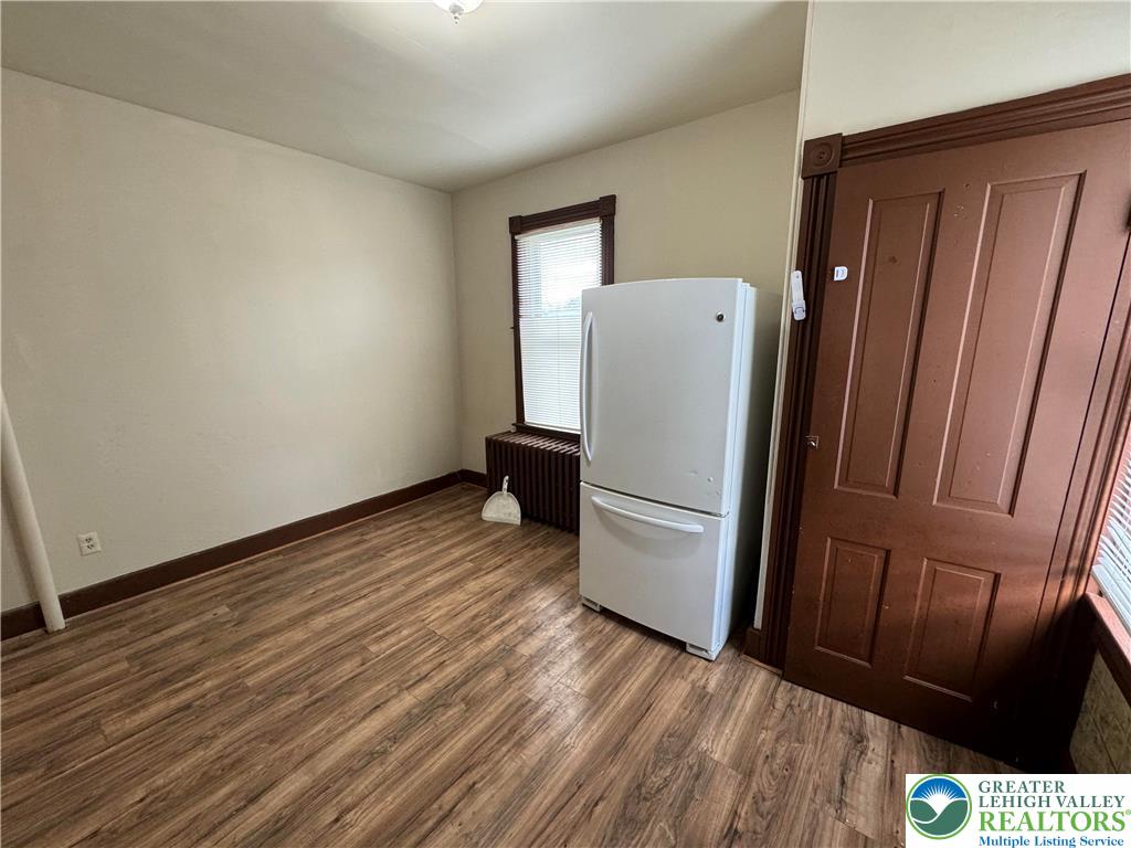 1503 Washington Street, Unit 2 Wilson, PA 18042 - Photo 7 of 28 a view of a refrigerator in kitchen and wooden floor