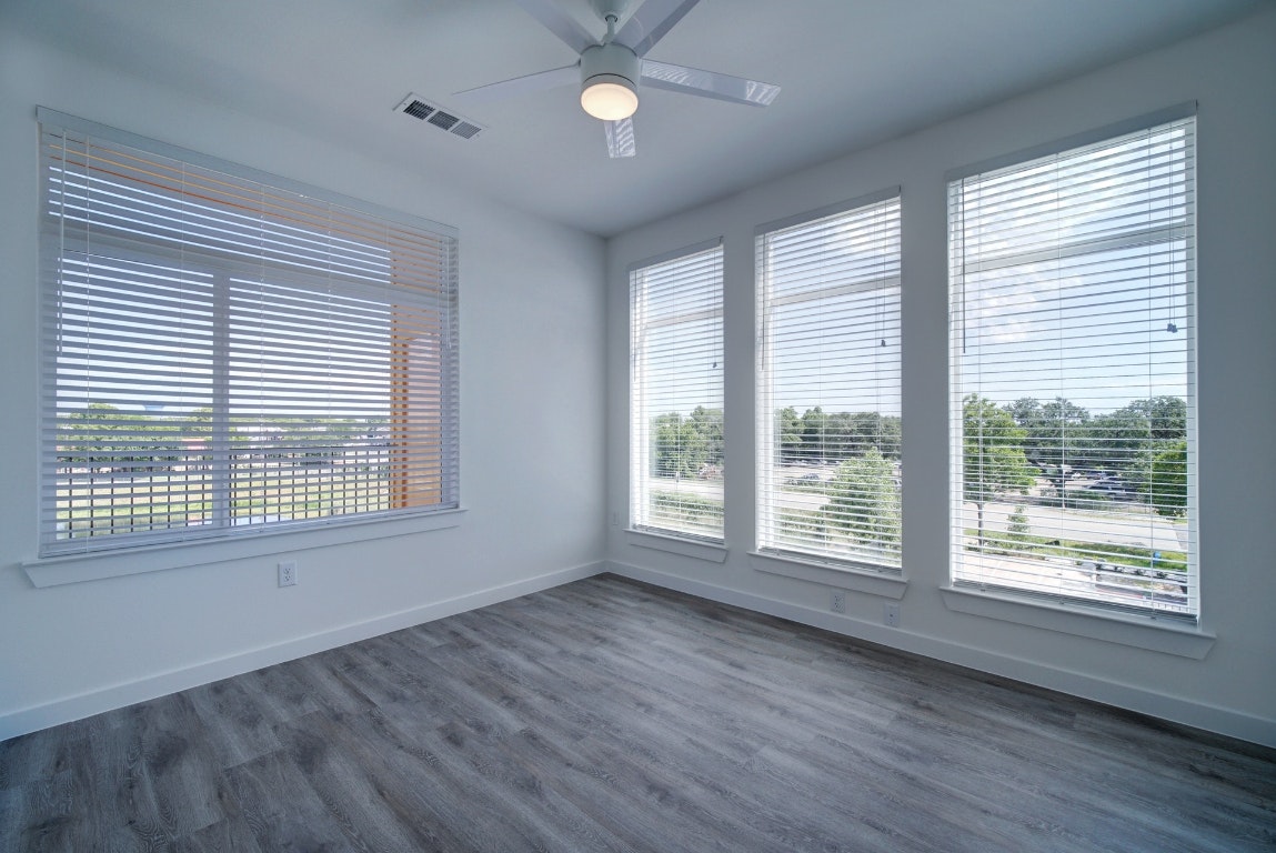 13130 Pond Springs Road, Unit 3212 Austin, TX 78750 - Photo 22 of 33 a view of an empty room with wooden floor and a window
