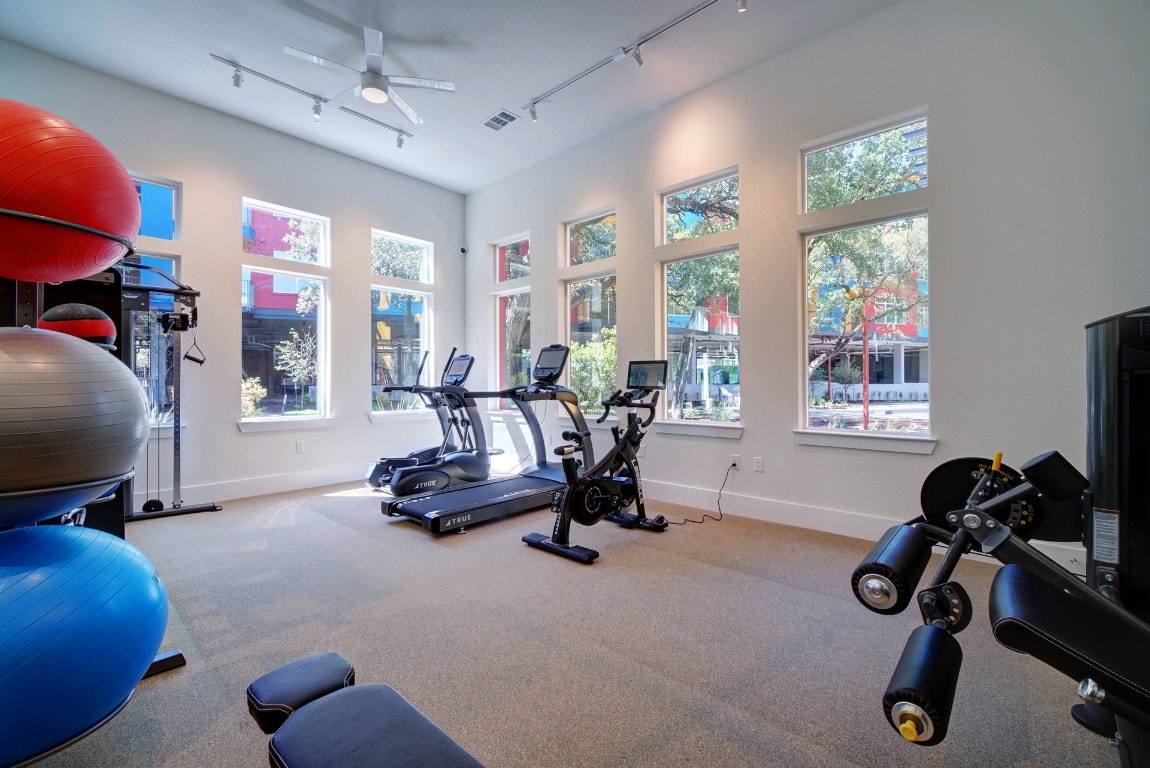 13130 Pond Springs Road, Unit 3212 Austin, TX 78750 - Photo 32 of 33 a room with gym equipment and a large window